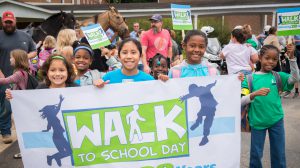 Students with a banner for Walk to School Day