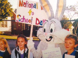 Photo of early Walk to School Day event with children and their school mascot.