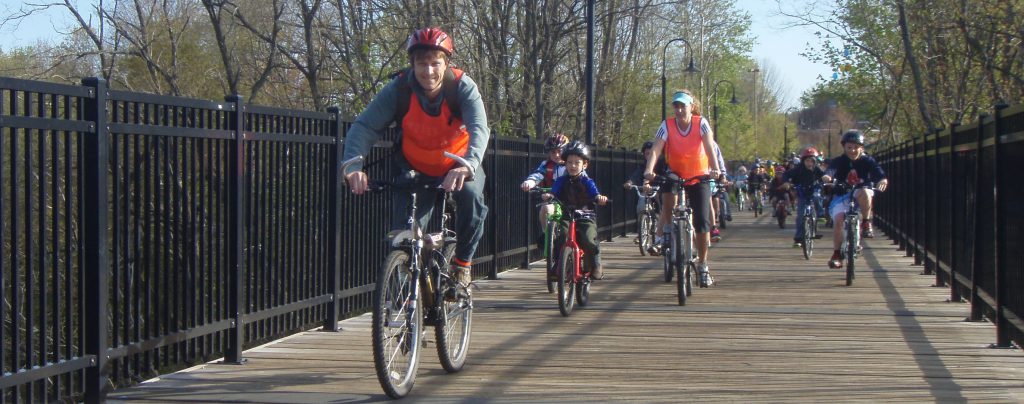 Parents and students ride their bikes in a bike train in Dover, New Hampshire.